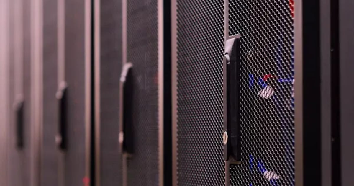 A row of closed server cabinets down a data centre aisle